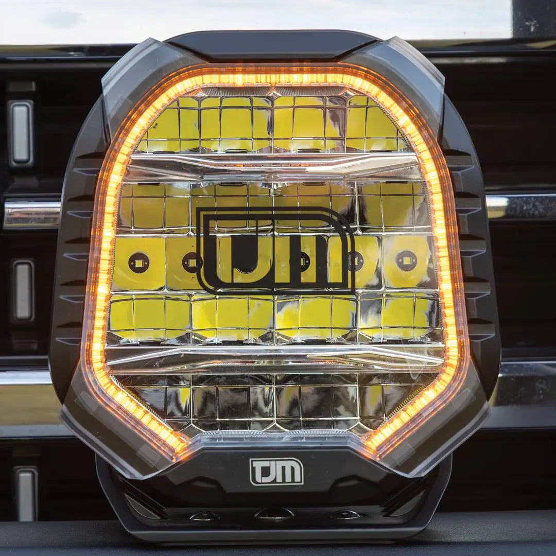 Close-up of TJM driving light with illuminated position light