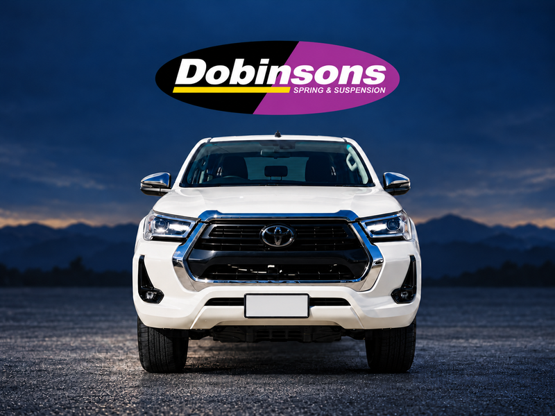 Toyota Hilux N80 front view with Dobinsons logo — vehicle illustration, not a confirmed installation
