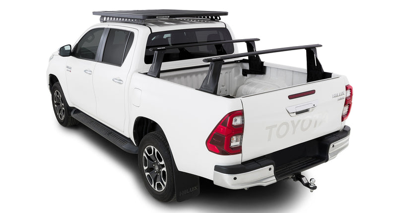 Reconn-Deck Vortex tub bars – installed Hilux view. Supplier photographs show the Hilux tub-mounted system. The separate cab-roof rack, vehicle and other accessories pictured are not included.