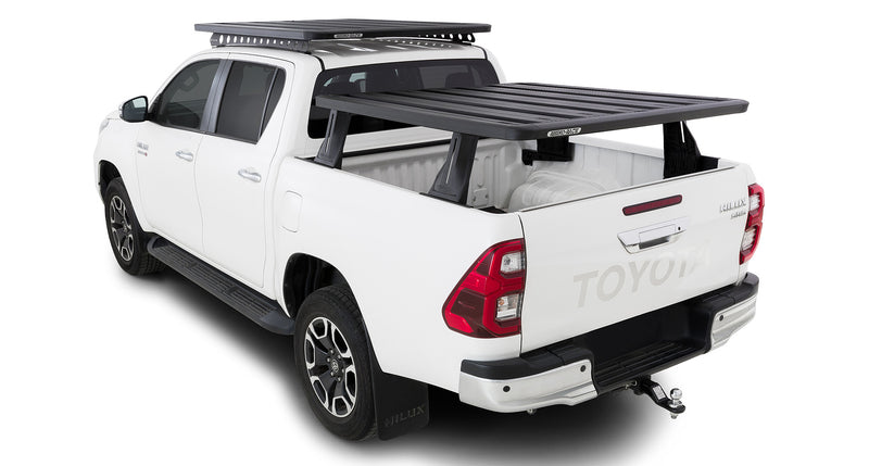 Reconn-Deck Pioneer 5 tub platform – installed Hilux view. Supplier photographs show the Hilux tub-mounted system. The separate cab-roof rack, vehicle and other accessories pictured are not included.