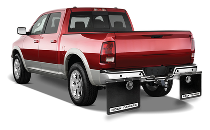 Rock Tamers exhaust outlets installed on a vehicle's mudflaps, angled view