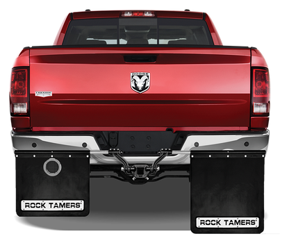 Rock Tamers exhaust outlets installed on a vehicle's mudflaps, rear view